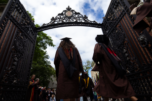 graduates walking through gates