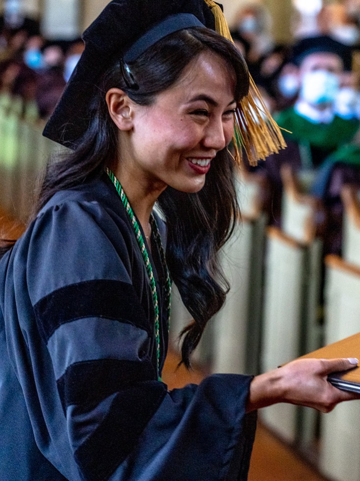 person in graduation cap and gown