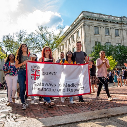 Students walking with a banner