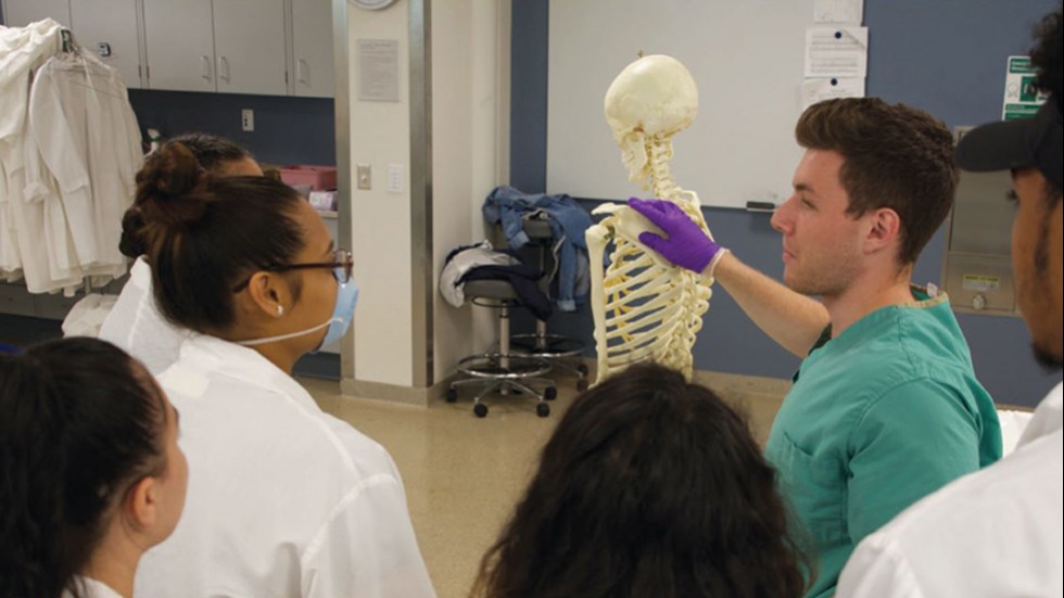 Medical student gives high school students a tour of the anatomy lab