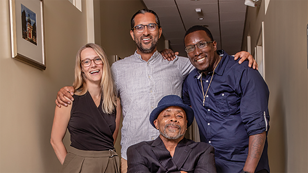 four people posing for a photo