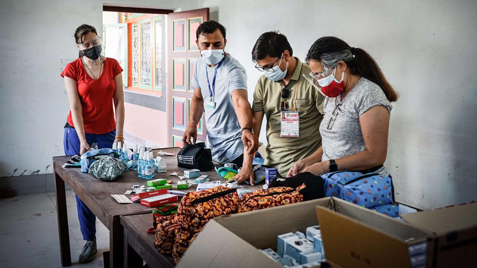 people in masks working at a table